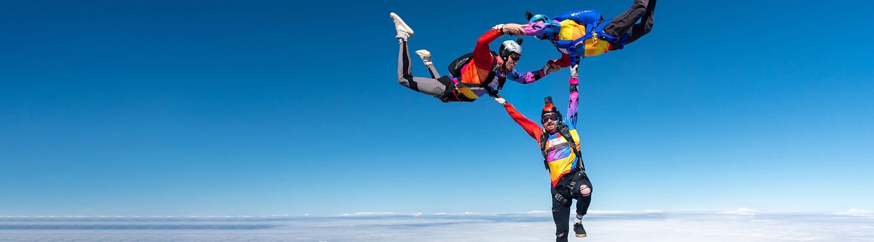 Three Skydive Downunder team members doing a formation skydive