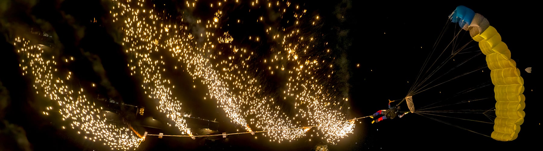 Skydiving at night, swooping with fireworks.