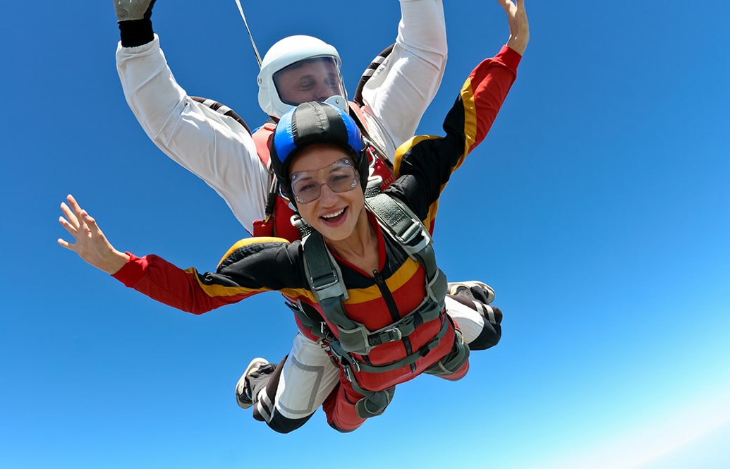 A tandem master and student illustrating safe skydiving techniques and equipment.