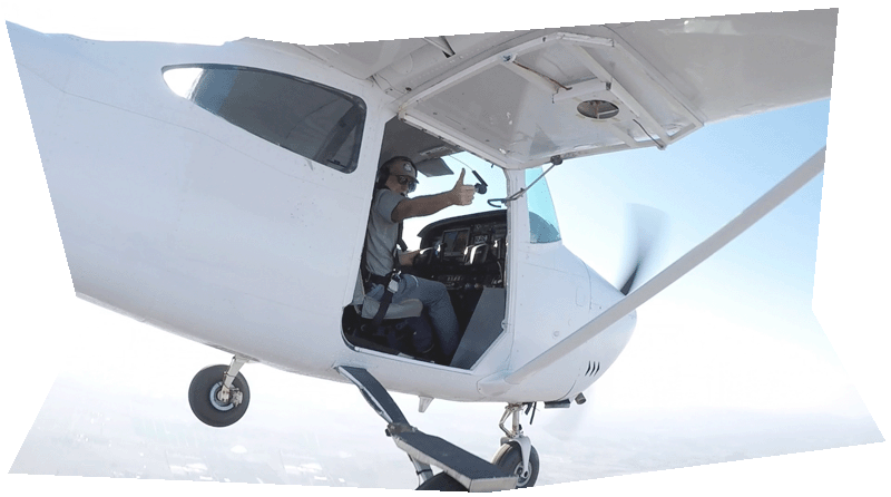 Pilot Don giving the thumbs up to the divers who have just exited the plane he is flying.