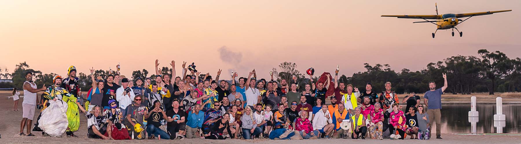 Skydiving community at its best. A group of skydivers after an amazing day of skydiving with a plane overhead.